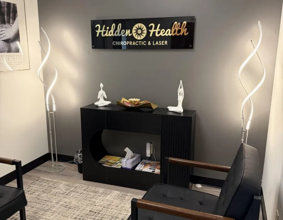 Reception lounge with the Hidden Health sign and soft lighting