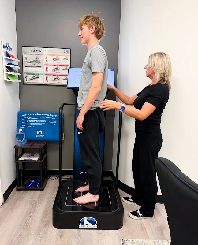 Dr. Shona checking a patient’s posture on the 3D scanner for a Nexi custom pillow